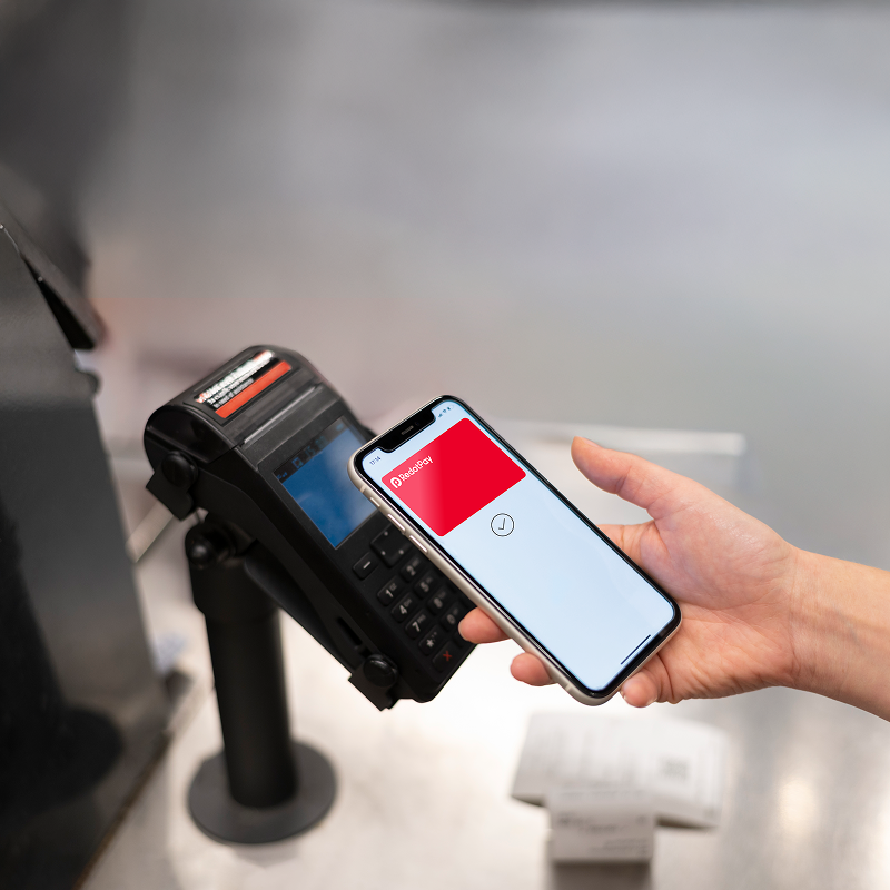 A customer making a contactless mobile payment at a payment terminal